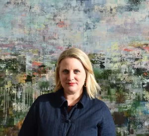 Emma standing in front of her painting